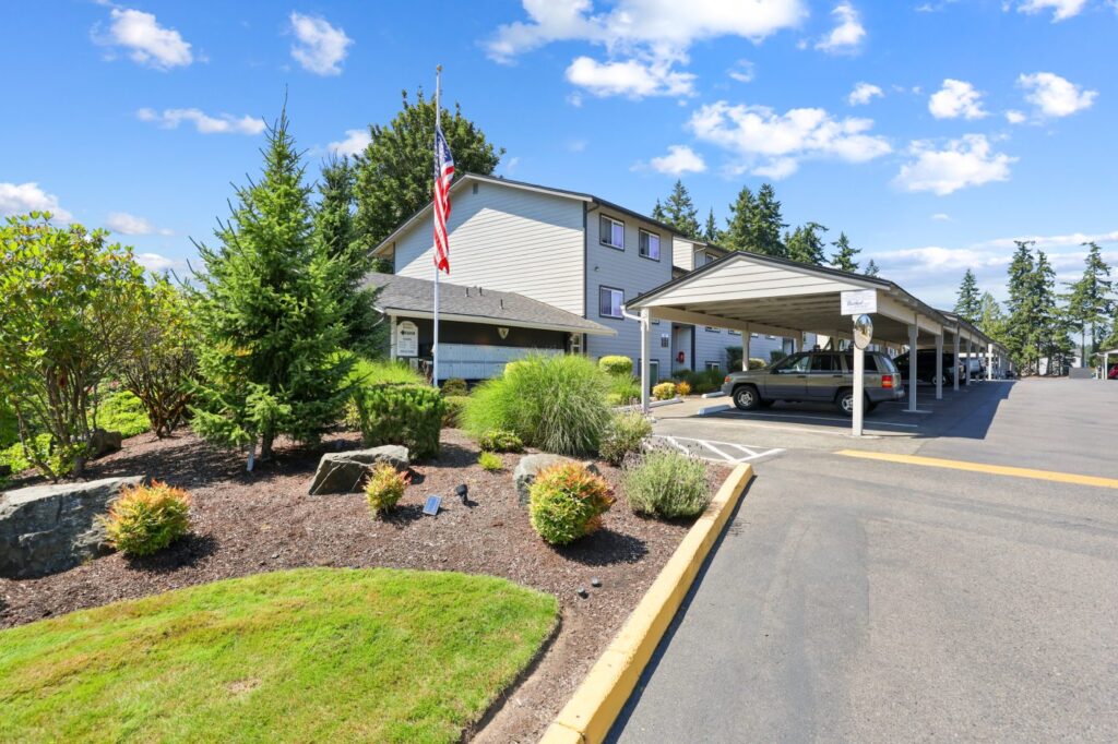 Scandia Knolls Apartments exterior with landscaped grounds and covered parking, Poulsbo WA